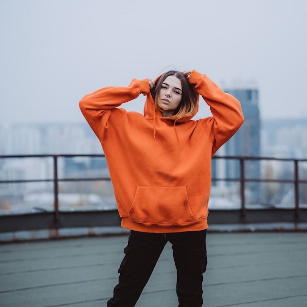 young-woman-orange-sweatshirt-poses-roof-building-city-center_1153-4958.jpg Oversized Pullover Hoodie - Image 1